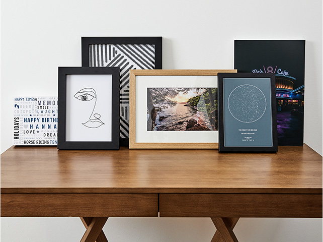 framed canvases on a table